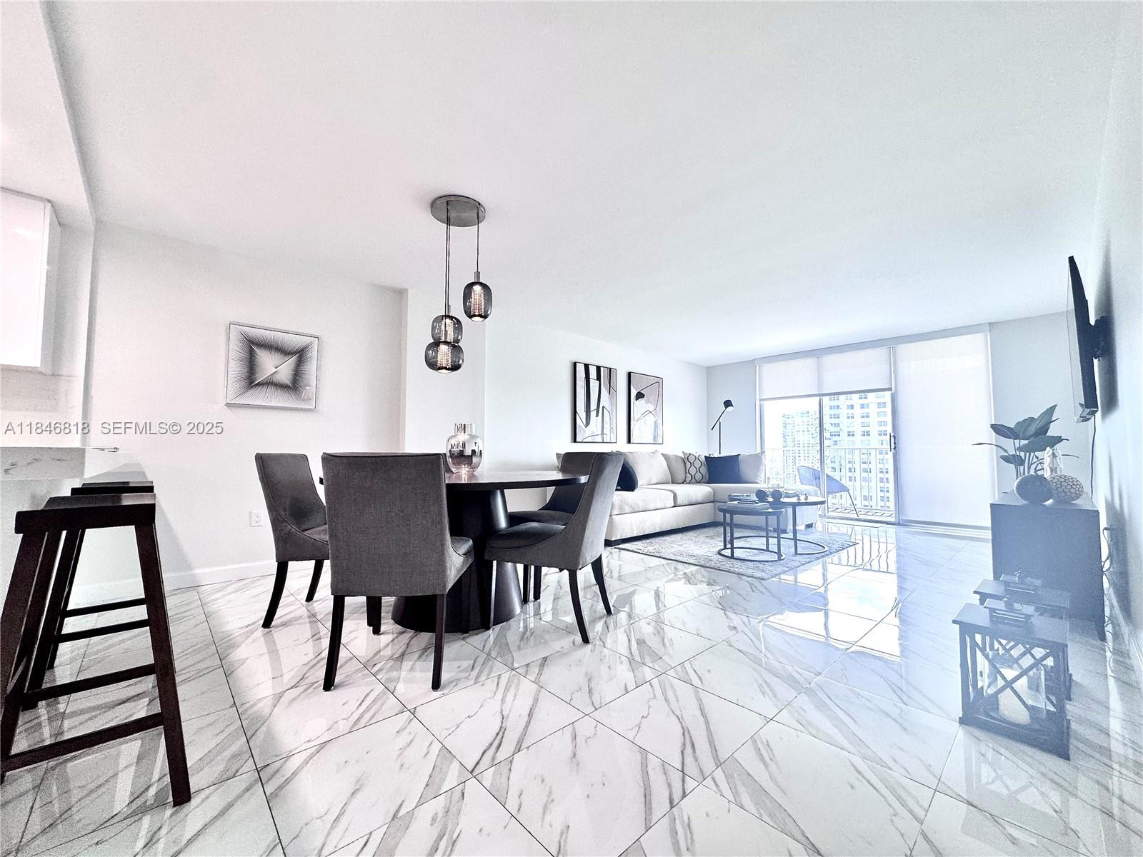2851 Northeast 183rd Street, Unit 1508E Aventura, FL 33160 - Photo 8 of 27 a view of a dining room with furniture and wooden floor