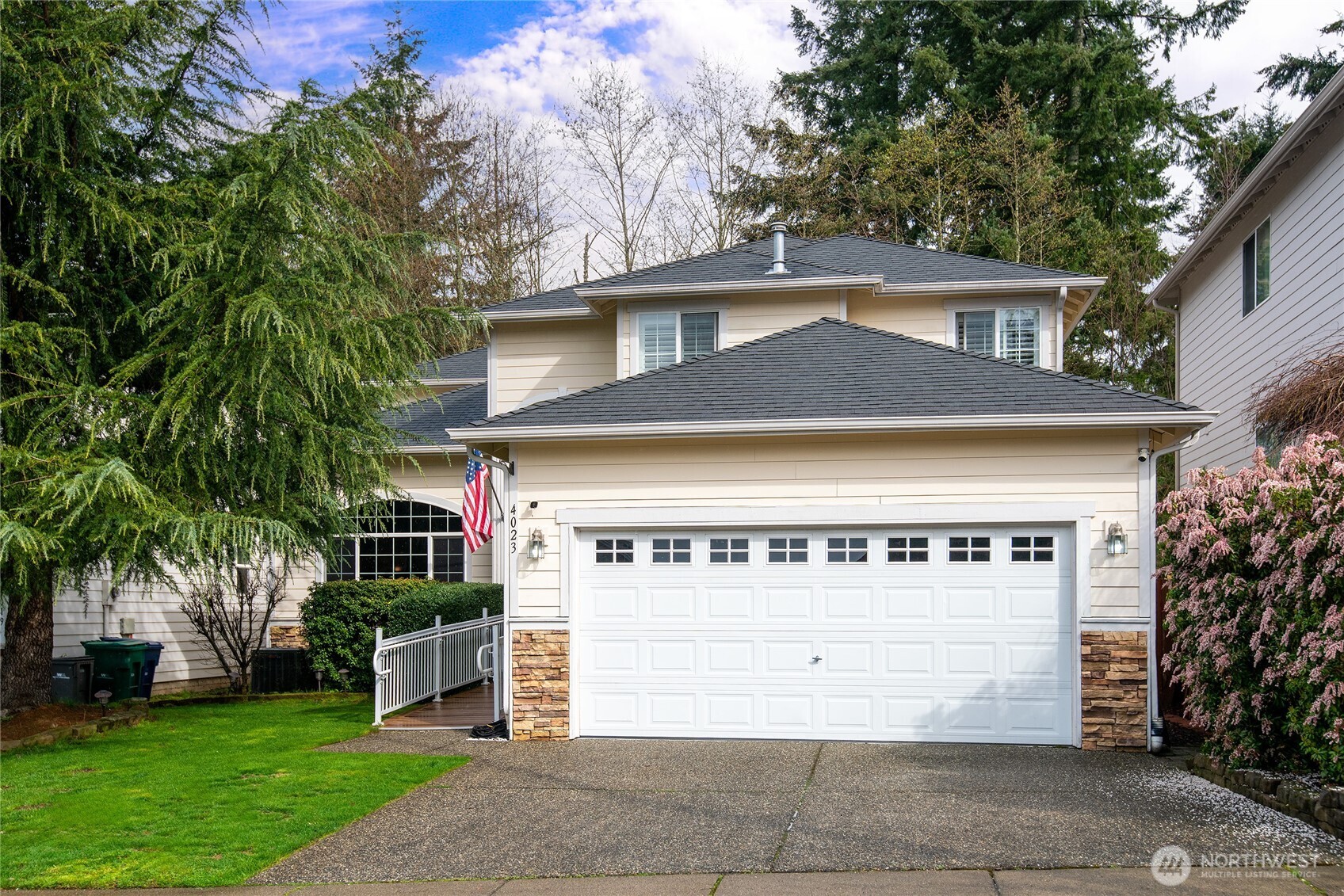 a front view of a house with a garden