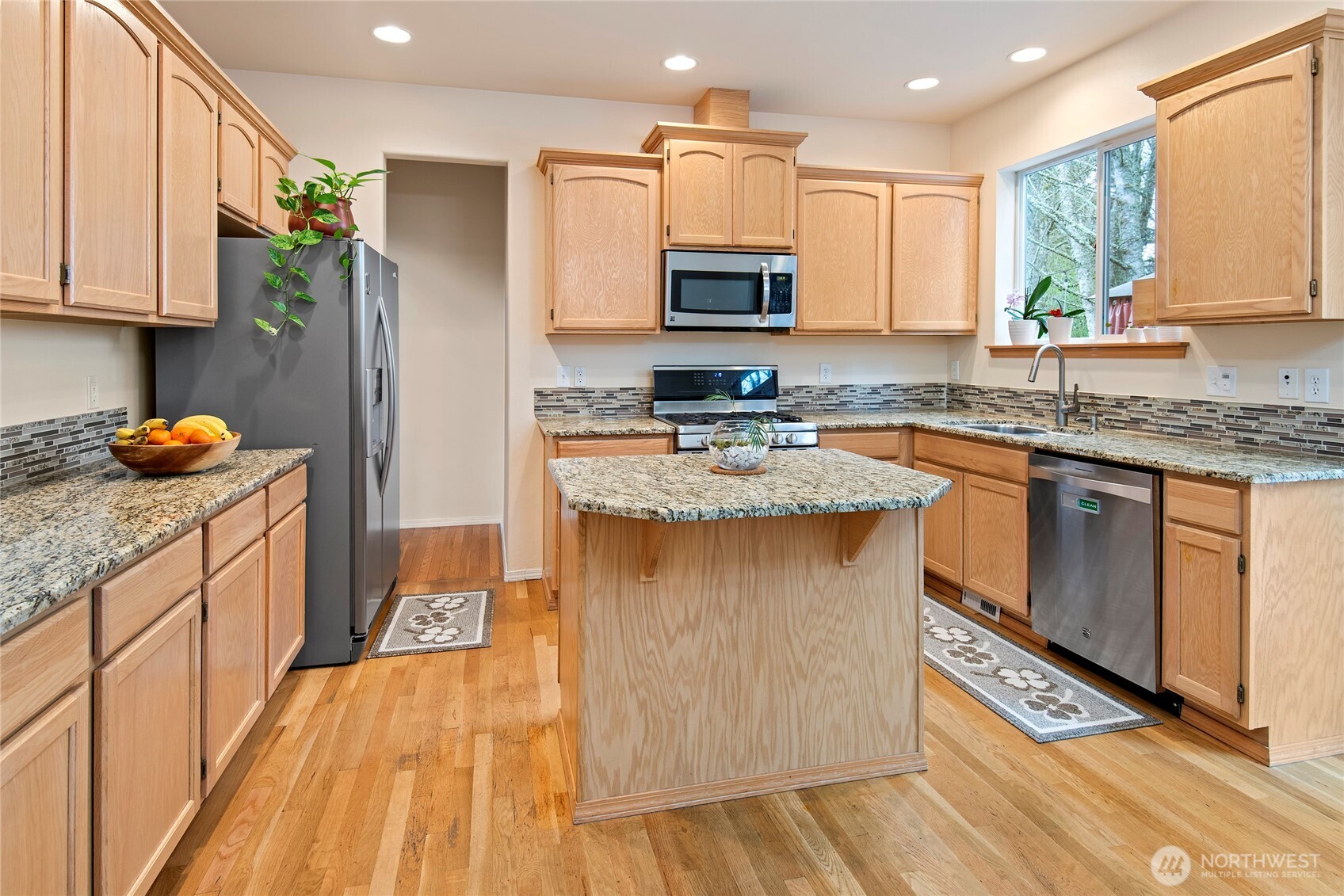 4023 160th Place Southeast Bothell, WA 98012 - Photo 7 of 22 a kitchen with stainless steel appliances granite countertop a stove a sink dishwasher and a refrigerator
