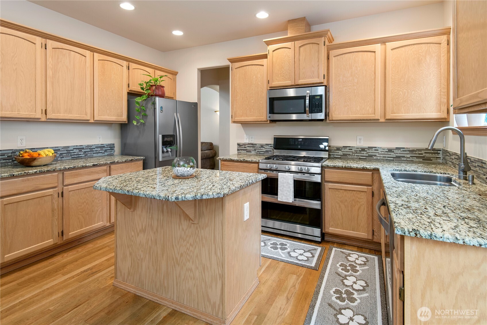 4023 160th Place Southeast Bothell, WA 98012 - Photo 8 of 22 a kitchen with stainless steel appliances granite countertop a stove top oven a sink and a granite counter tops