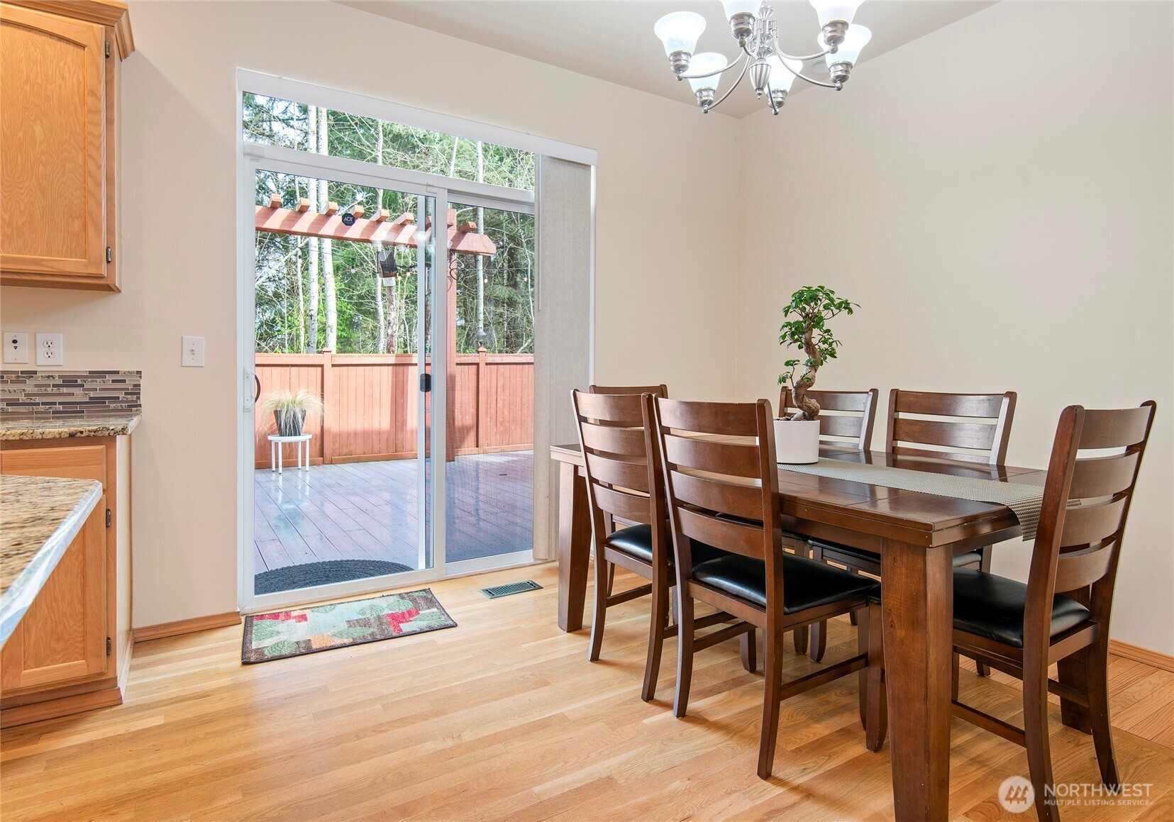 4023 160th Place Southeast Bothell, WA 98012 - Photo 9 of 22 a dining room with furniture a rug a potted plant and a chandelier