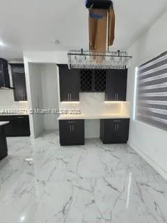 a view of kitchen with stainless steel appliances cabinets and outdoor space