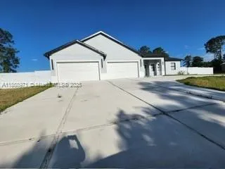 a view of parking space and yard