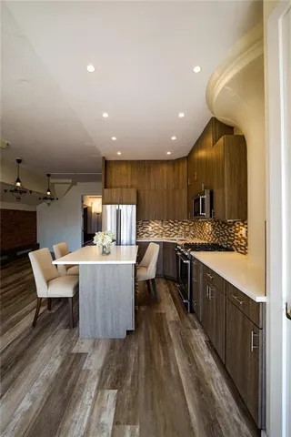 a kitchen with a sink and wooden floor