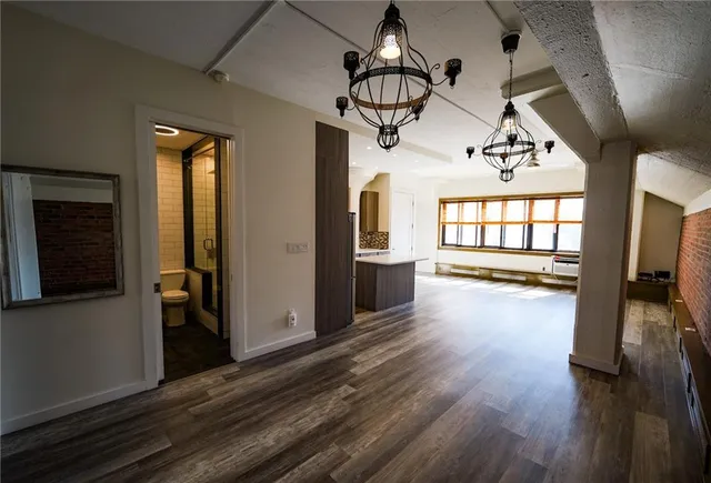 a view of a livingroom with wooden floor and windows