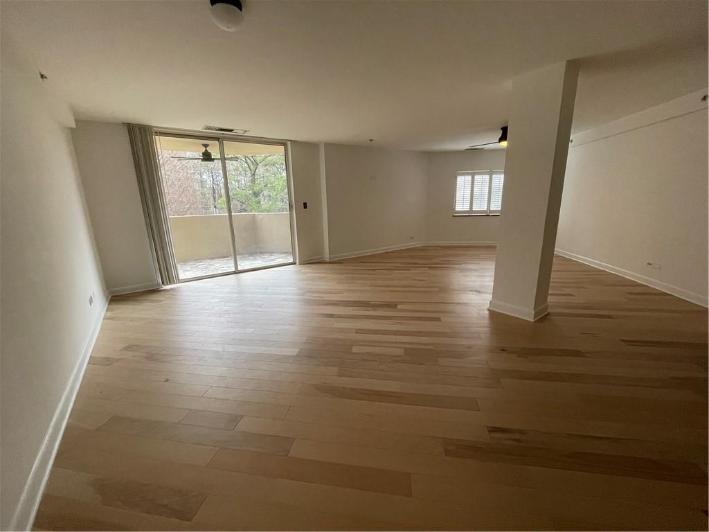 1501 Clairmont Road, Unit 532 Decatur, GA 30033 - Photo 3 of 17 a view of an empty room with wooden floor and a window