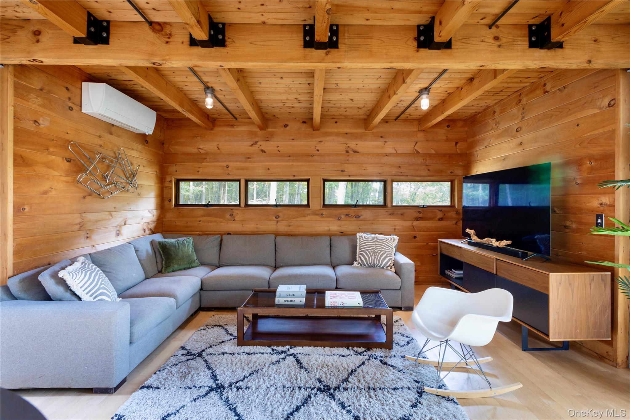 39 Hornbeck Road Accord, NY 12404 - Photo 11 of 24 Living area with wood walls, a wood ceiling with exposed beams, wood finished floors, healthy amount of natural light, and a wall mounted AC