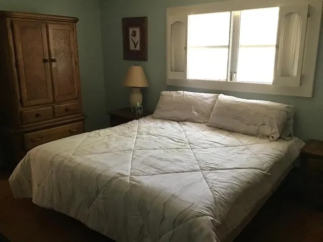 a bedroom with a bed and a window