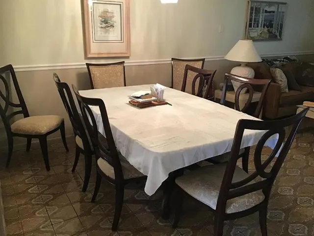 a view of a dining room with furniture and wooden floor