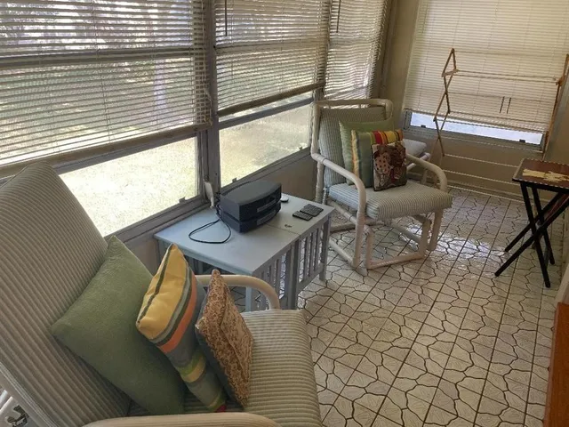 a living room with a table and a flat screen tv