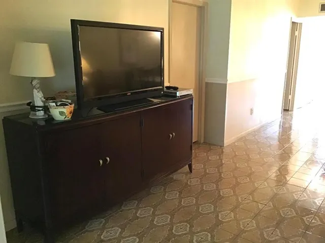 a living room with furniture a dining table and a fireplace