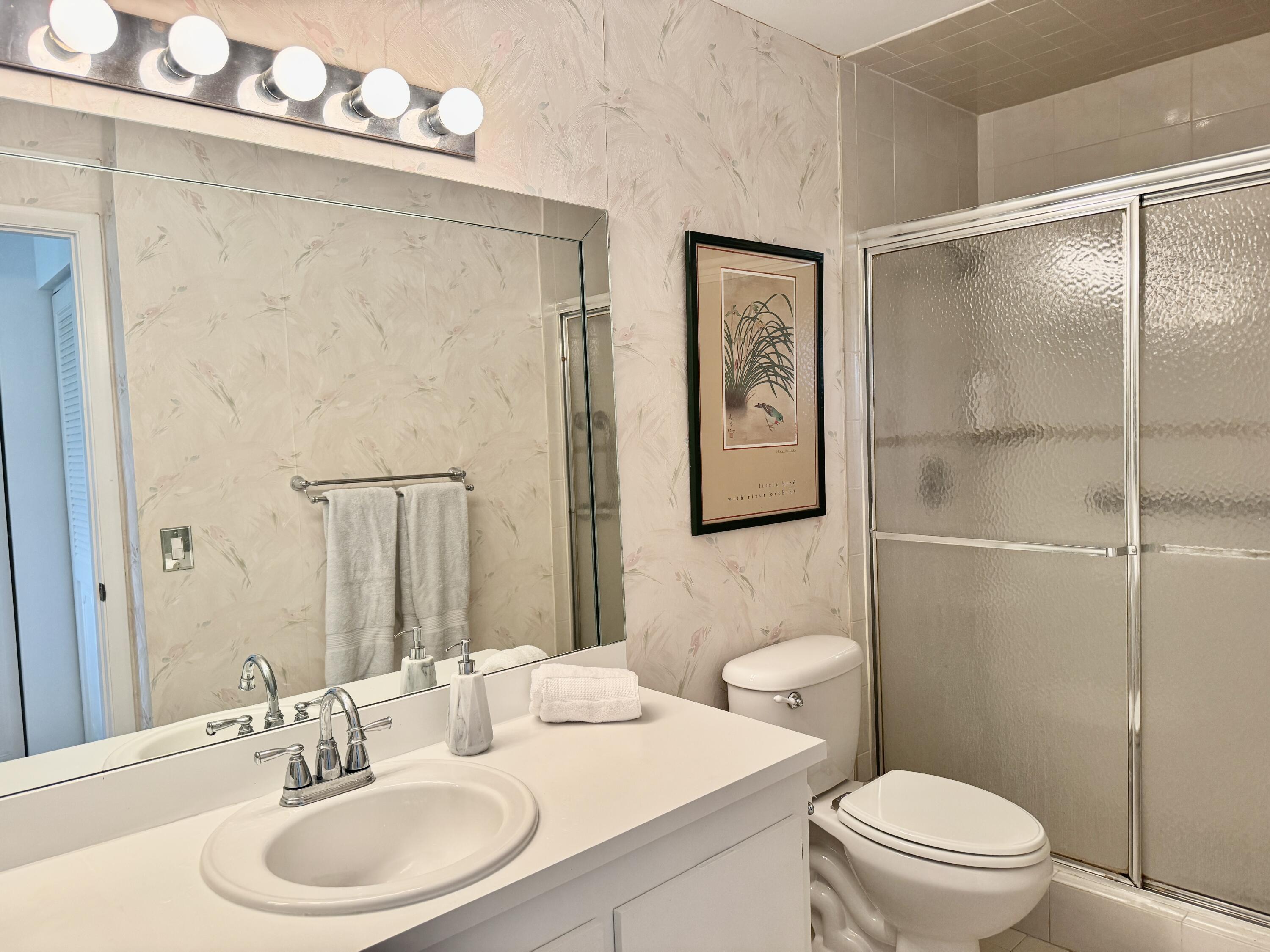 2840 Casa Way, Unit 201 Delray Beach, FL 33445 - Photo 11 of 26 a bathroom with a sink toilet and shower