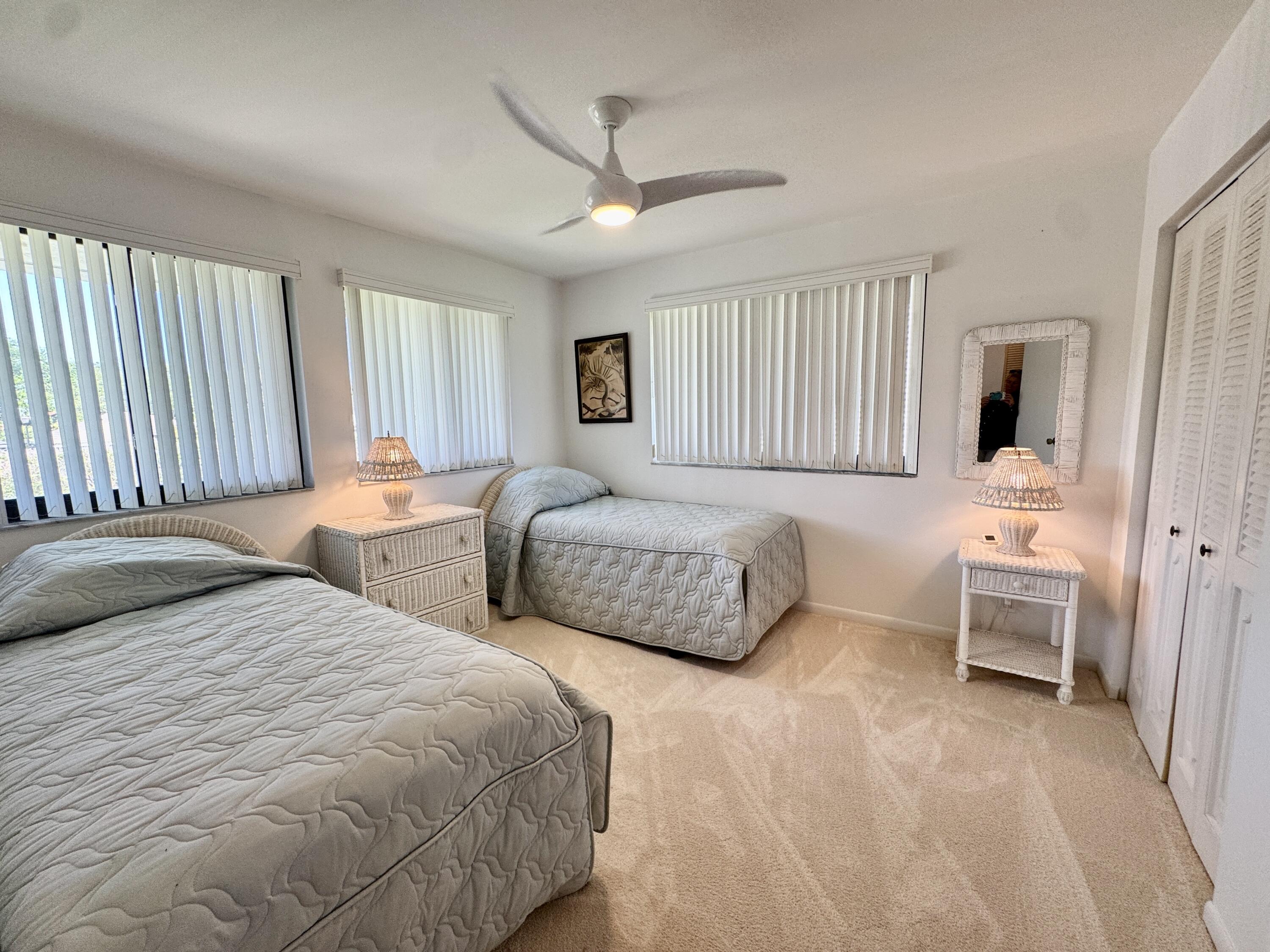 2840 Casa Way, Unit 201 Delray Beach, FL 33445 - Photo 13 of 26 a bedroom with two beds and a dresser