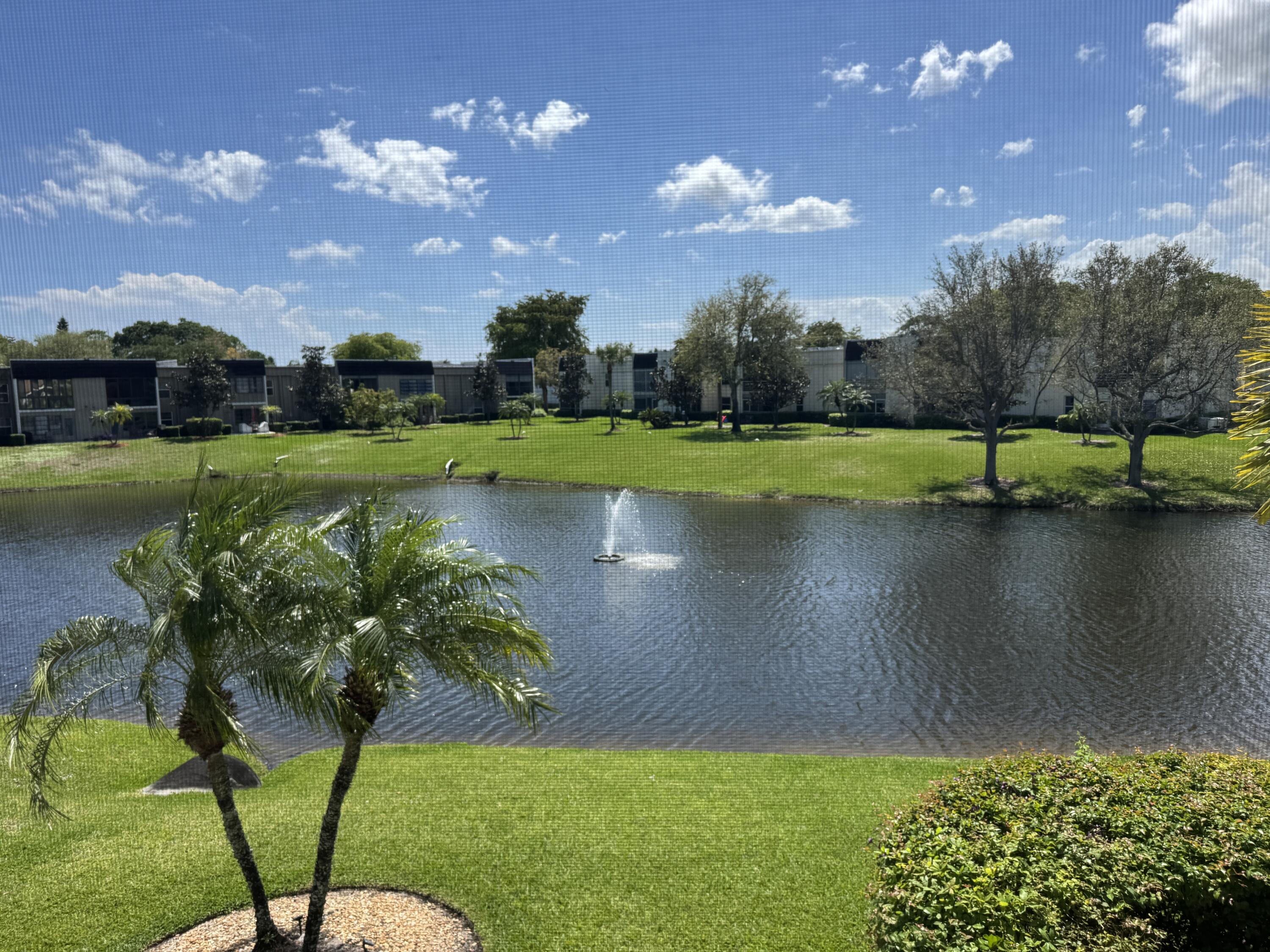 2840 Casa Way, Unit 201 Delray Beach, FL 33445 - Photo 15 of 26 a view of a lake with a yard