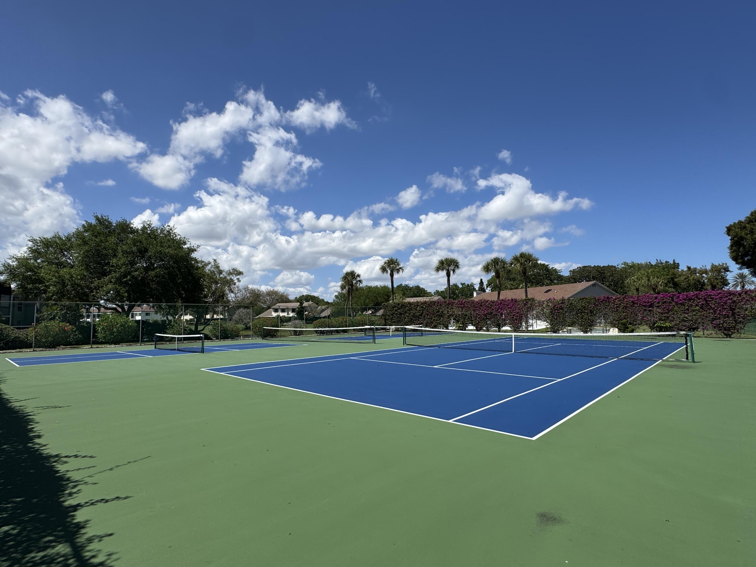 2840 Casa Way, Unit 201 Delray Beach, FL 33445 - Photo 16 of 26 a view of an outdoor space and tennis court