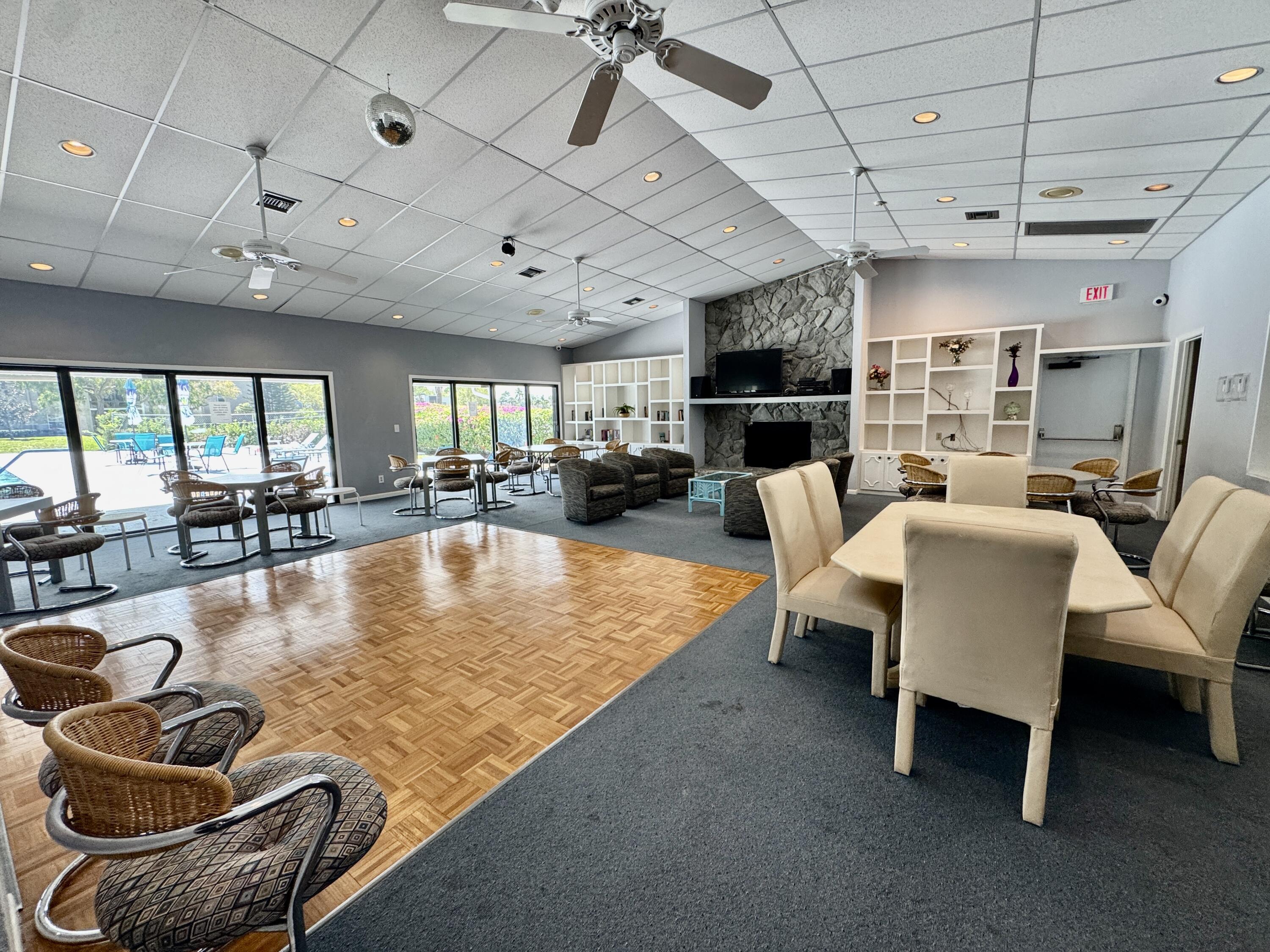 2840 Casa Way, Unit 201 Delray Beach, FL 33445 - Photo 20 of 26 a living room with furniture pool table and a fireplace