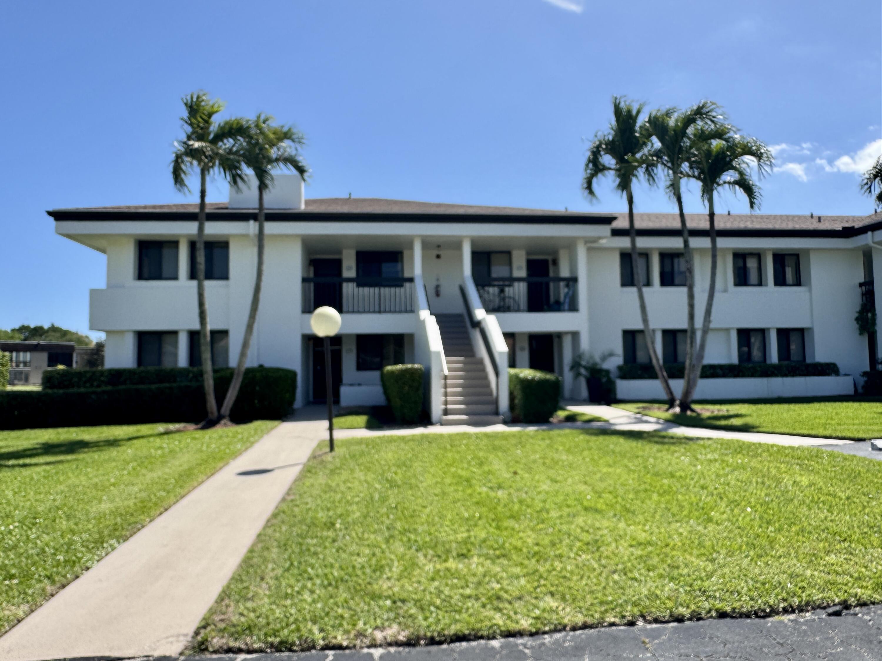 2840 Casa Way, Unit 201 Delray Beach, FL 33445 - Photo 2 of 26 a view of a house with swimming pool and a yard