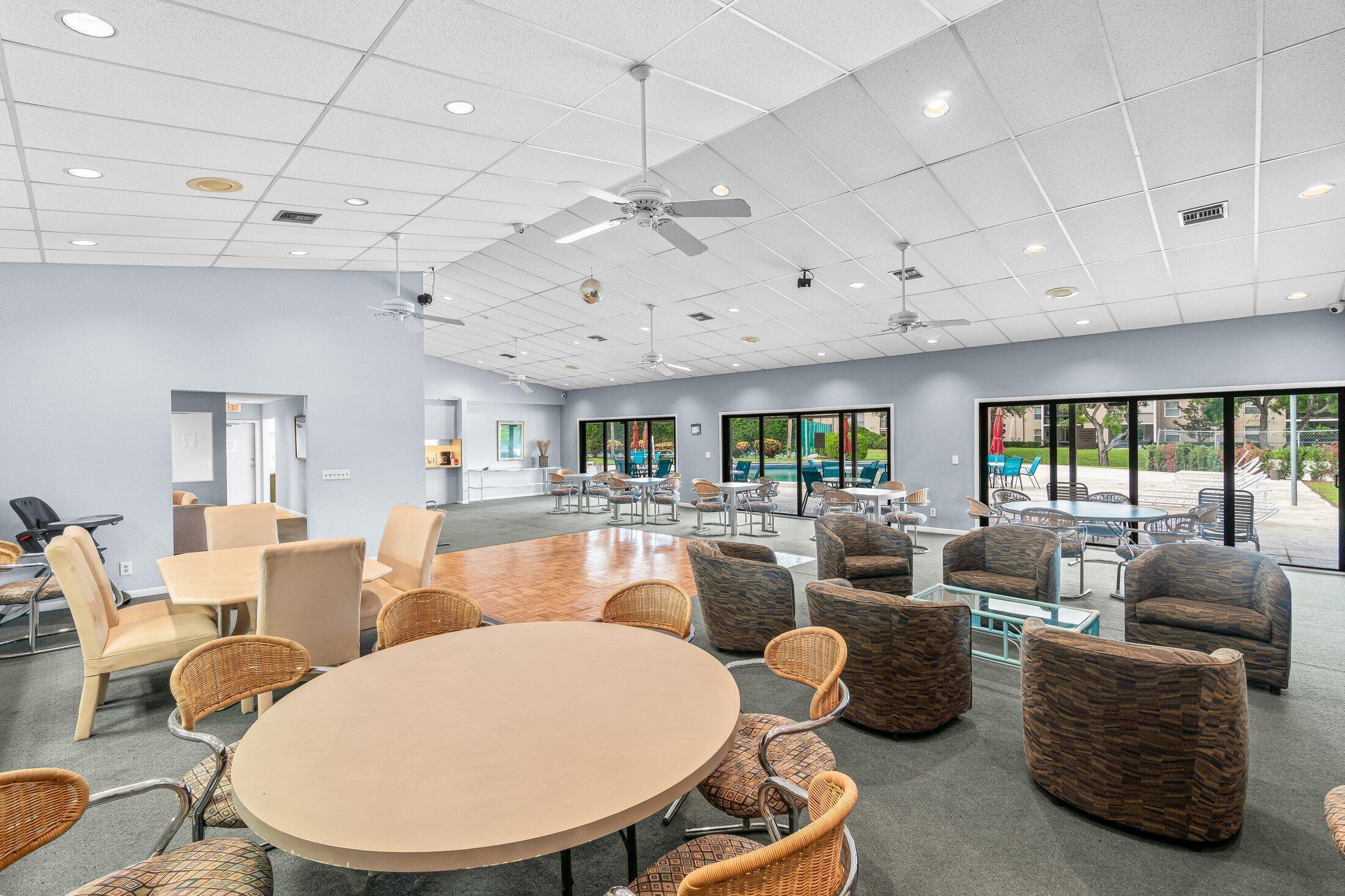 2840 Casa Way, Unit 201 Delray Beach, FL 33445 - Photo 23 of 26 a living room with furniture a fireplace and a large window