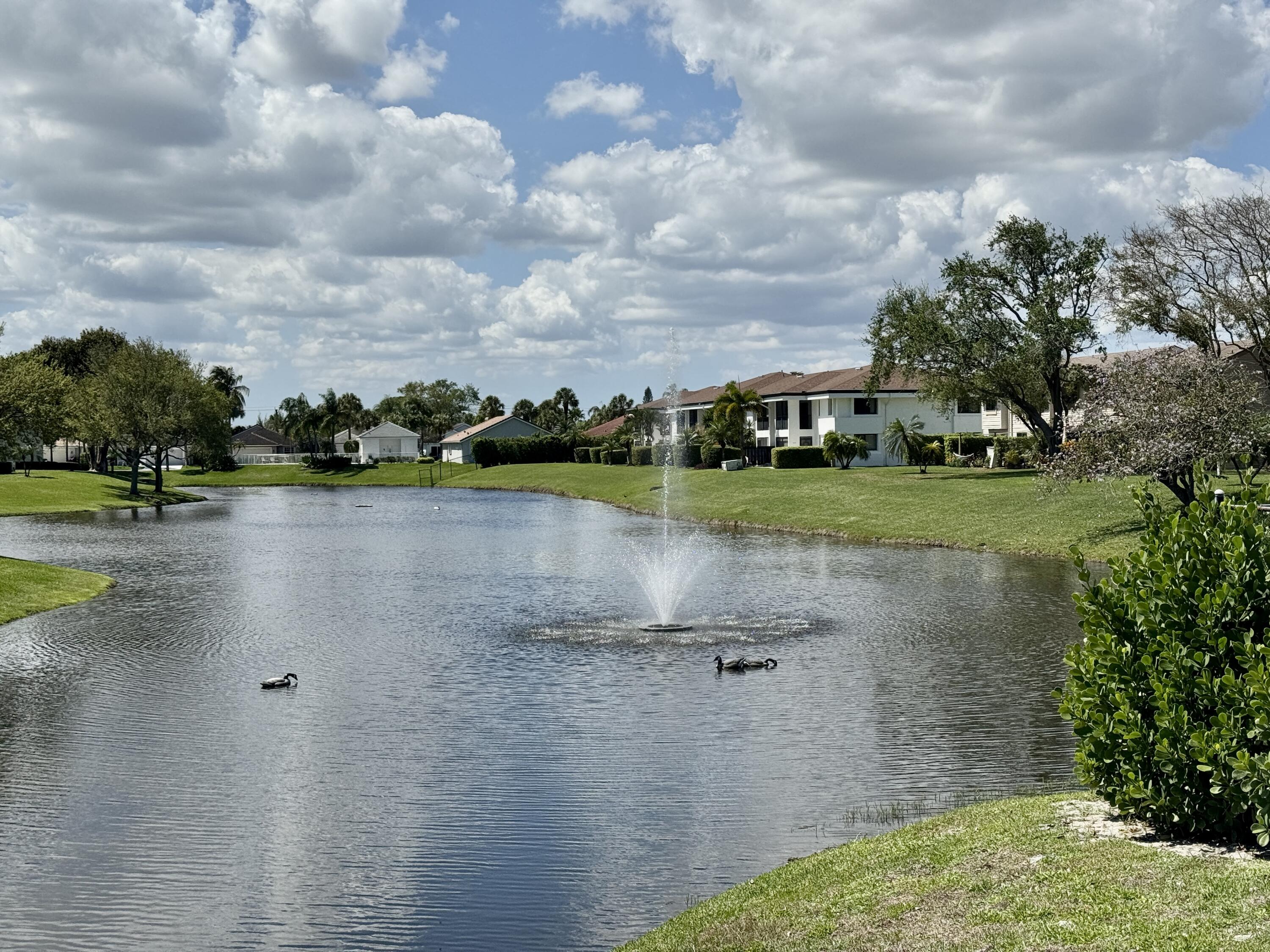 2840 Casa Way, Unit 201 Delray Beach, FL 33445 - Photo 26 of 26 a view of a lake with houses in the background