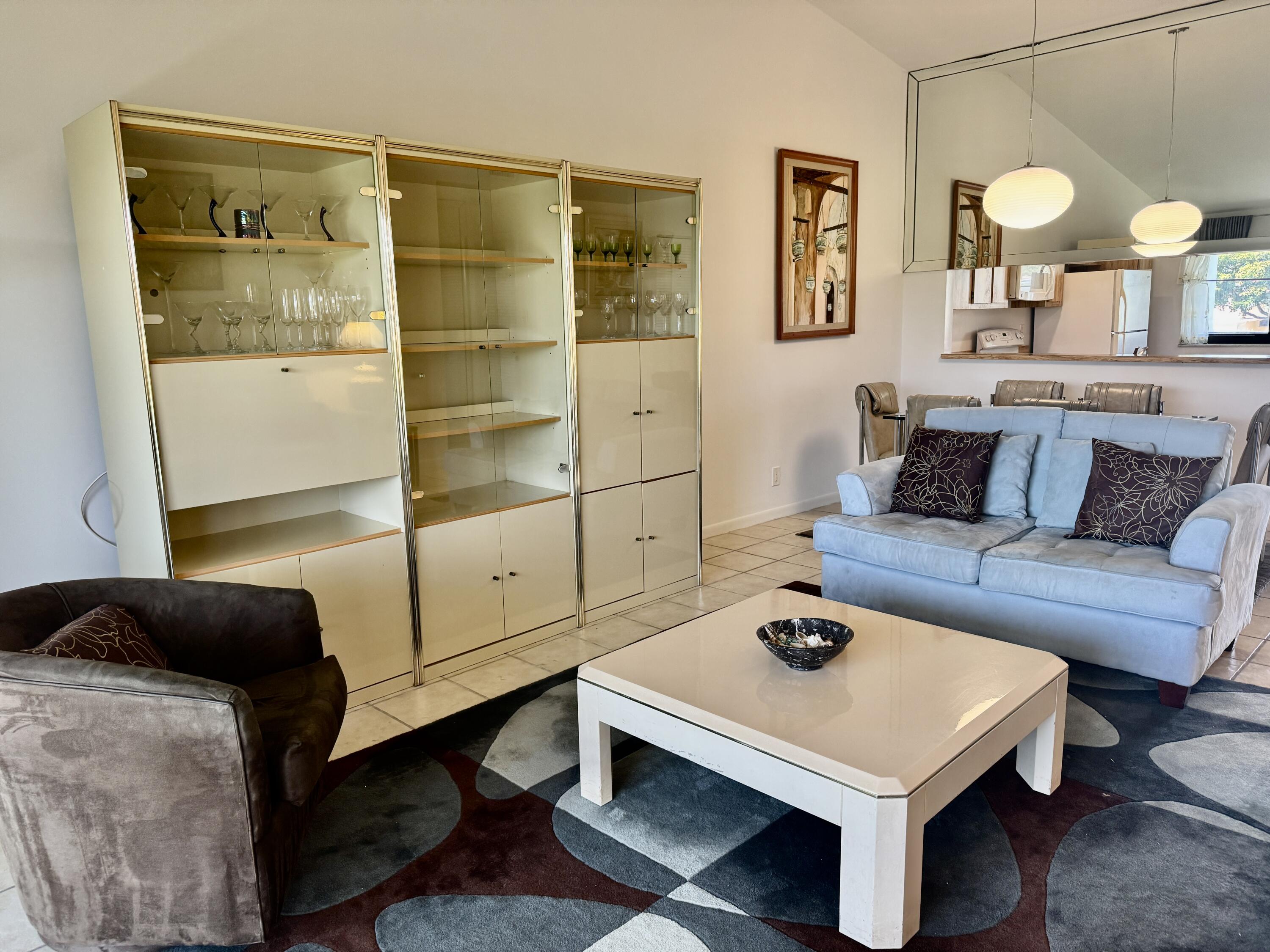 2840 Casa Way, Unit 201 Delray Beach, FL 33445 - Photo 3 of 26 a living room with furniture and a table