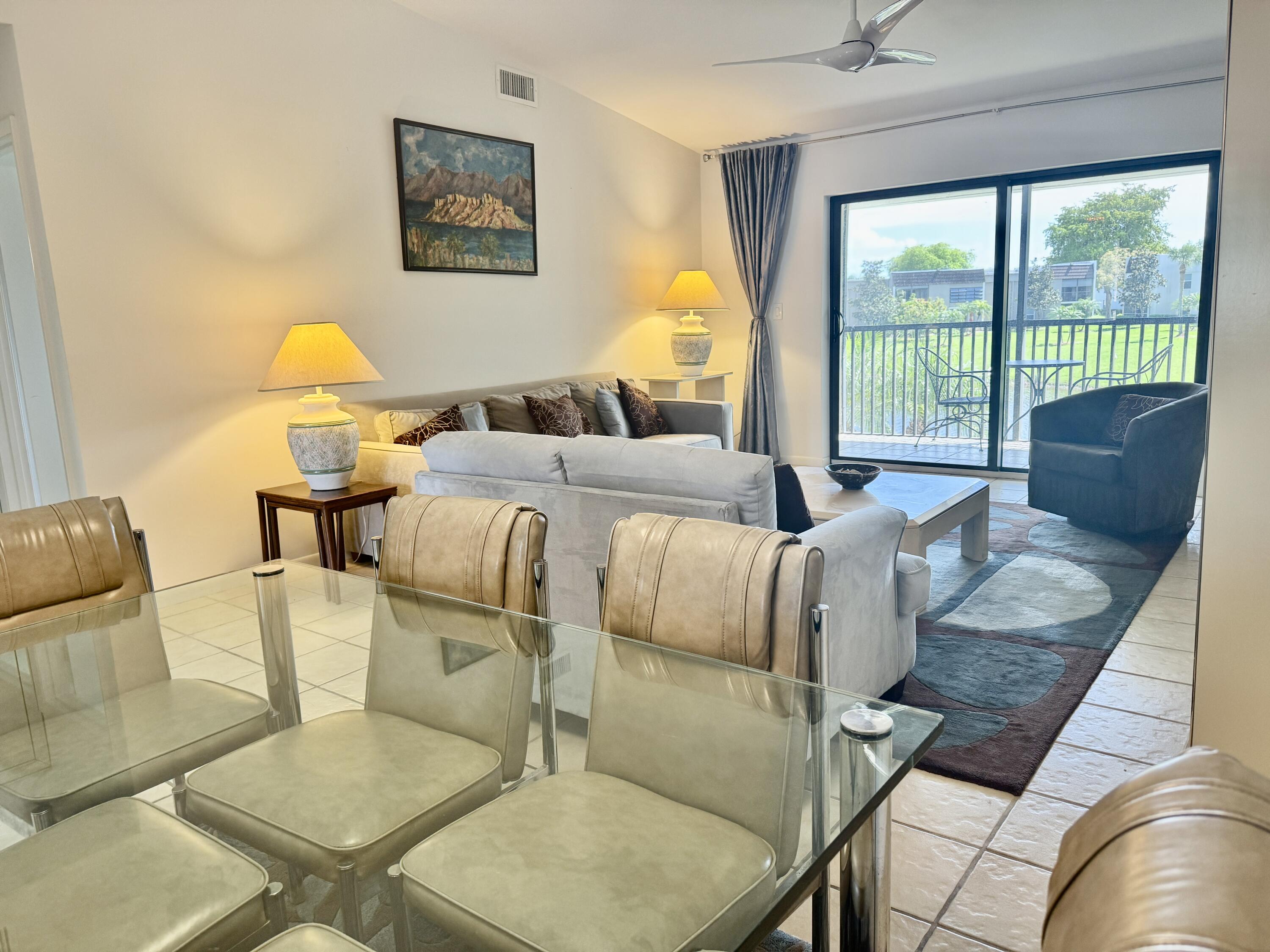 2840 Casa Way, Unit 201 Delray Beach, FL 33445 - Photo 4 of 26 a living room with furniture and a table