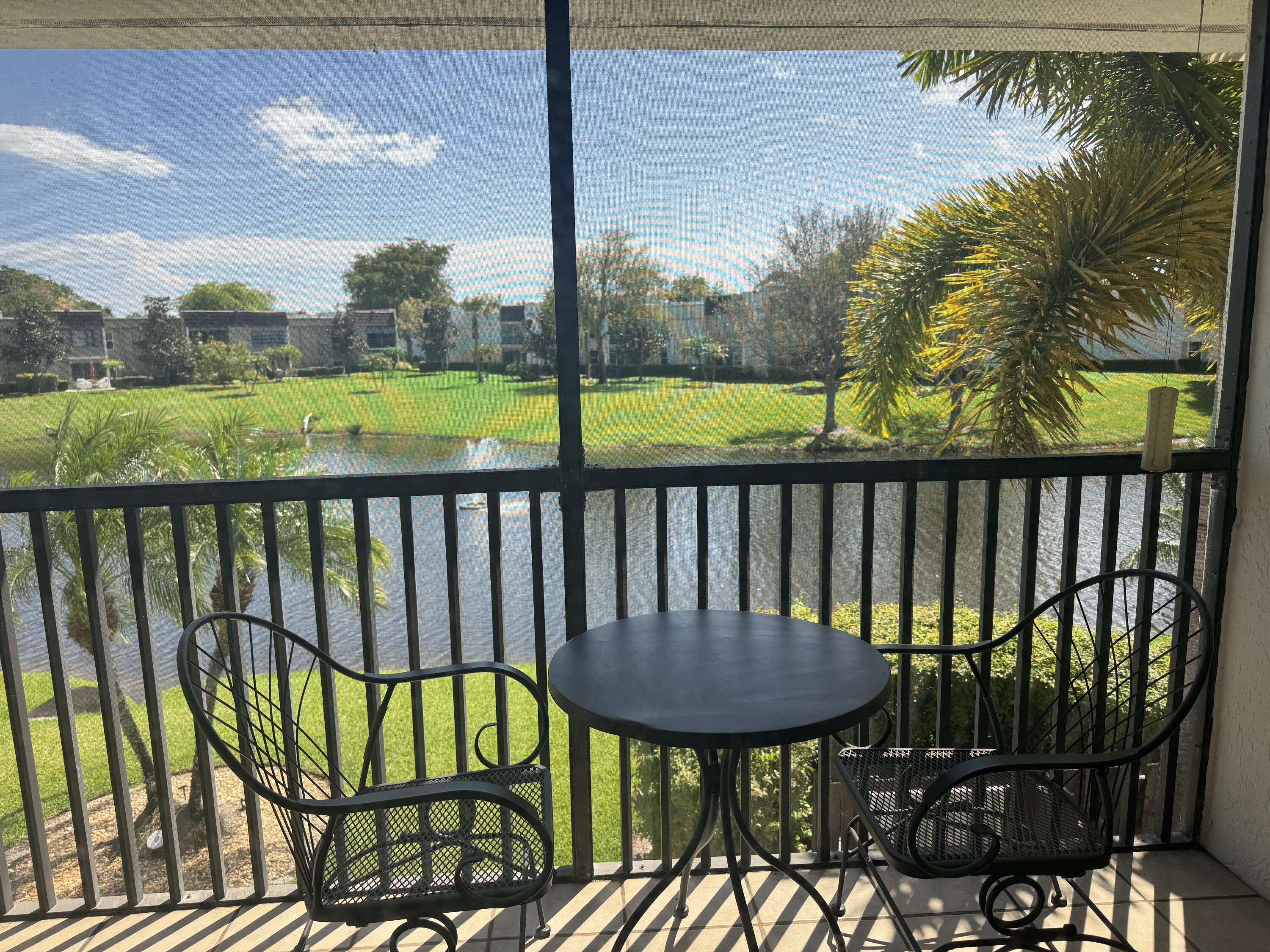 2840 Casa Way, Unit 201 Delray Beach, FL 33445 - Photo 7 of 26 a view of a chairs in patio