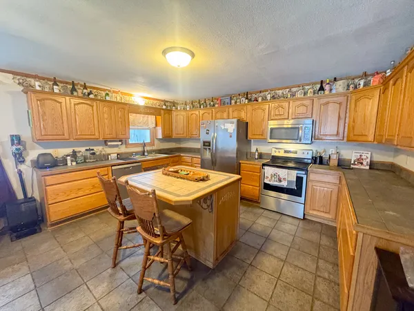 a kitchen with a stove a sink and a refrigerator