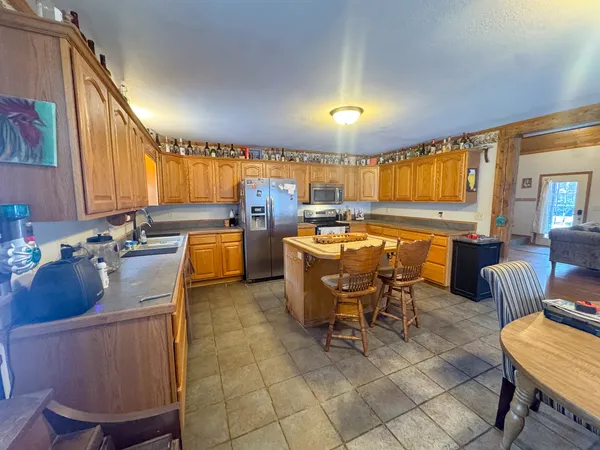 a large kitchen with a table and chairs