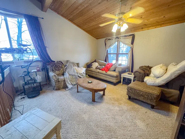 a living room with furniture a window and a chandelier