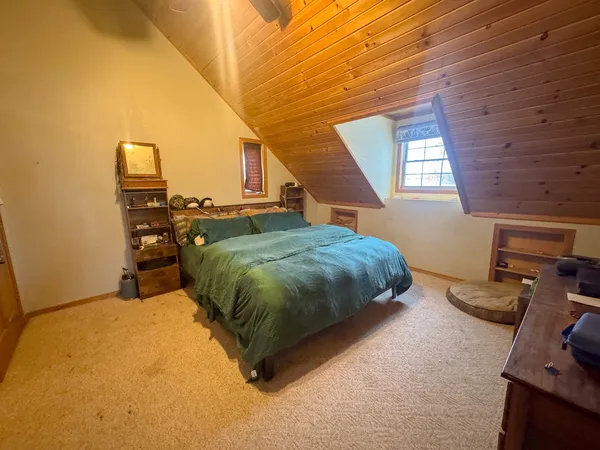 a bed sitting in a bedroom next to a window