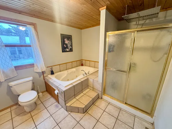 a bathroom with a tub and shower