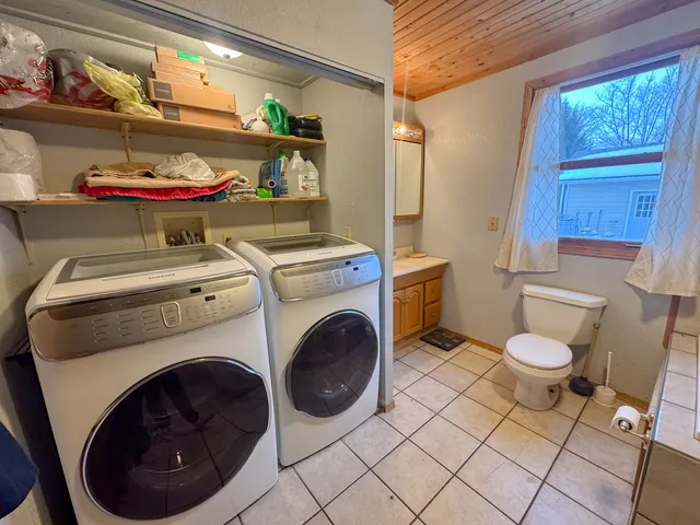 a bathroom with a toilet and a washing machine