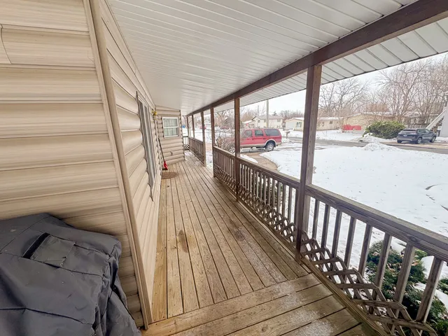 a view of a balcony with wooden floor