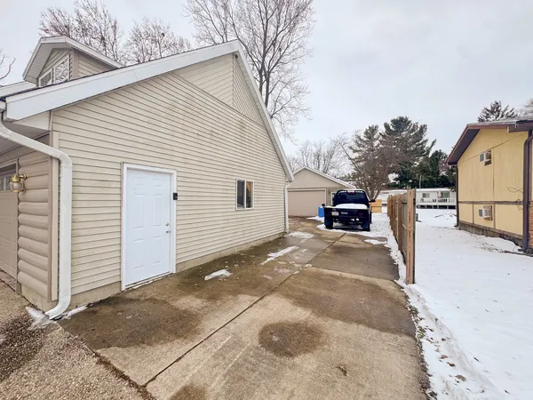 a view of a house with a snow on the road