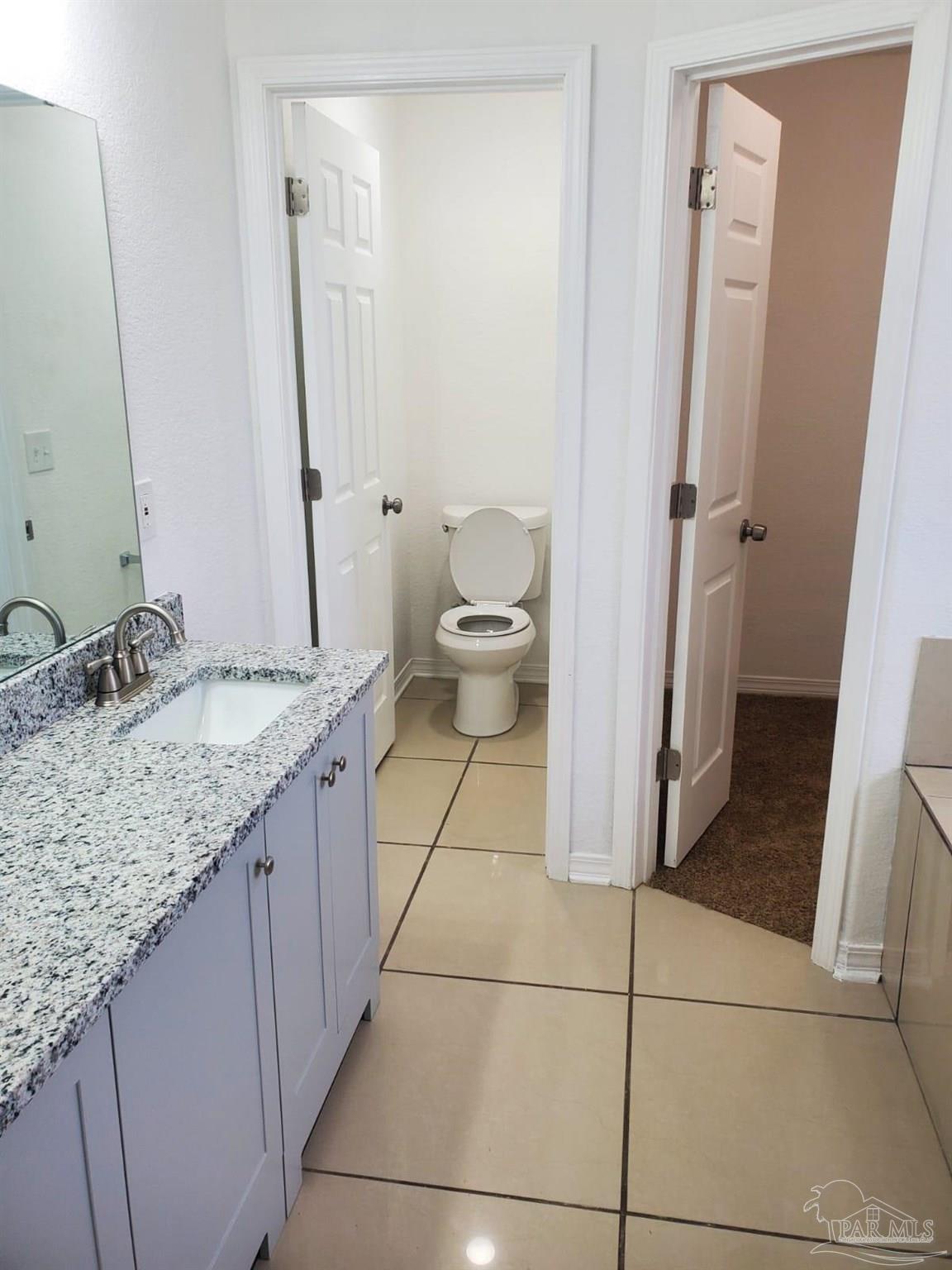 659 Griswold Road Jay, FL 32565 - Photo 24 of 42 a bathroom with a granite countertop sink and a mirror