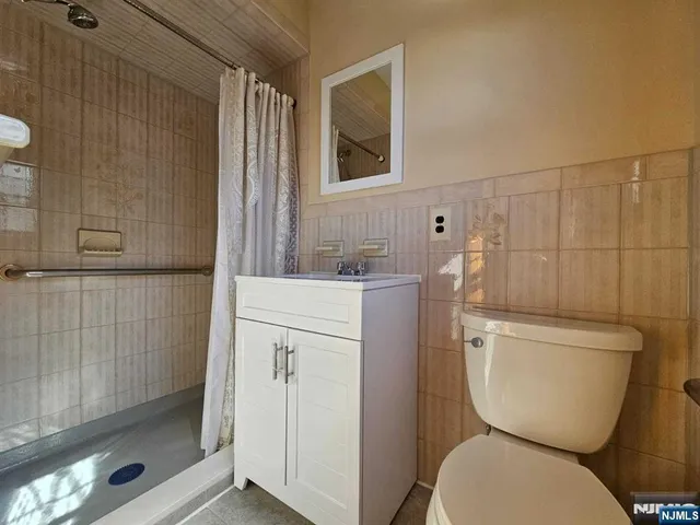 a bathroom with a toilet sink and shower