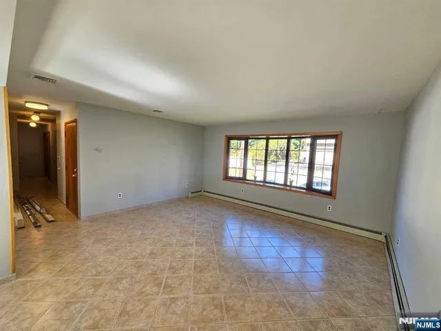 a view of an empty room and a window