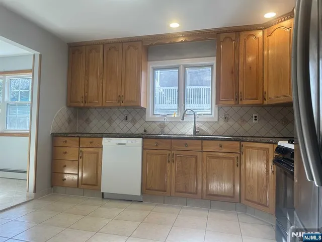 a kitchen with stainless steel appliances granite countertop a sink and cabinets