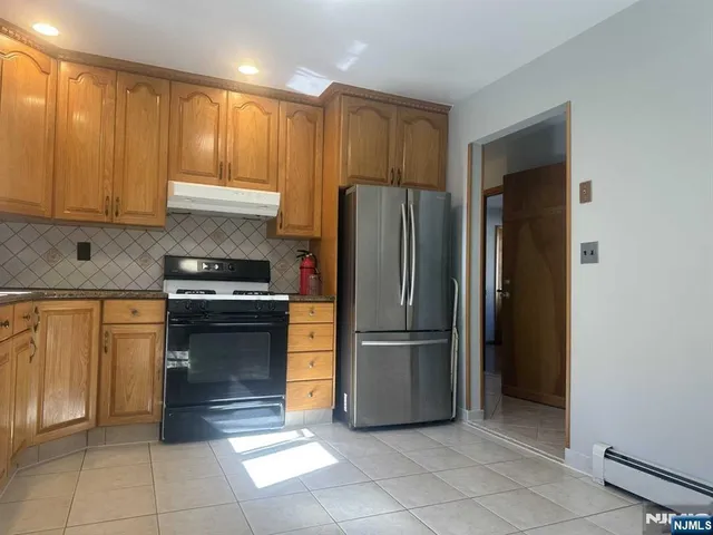 a kitchen with a refrigerator and a sink