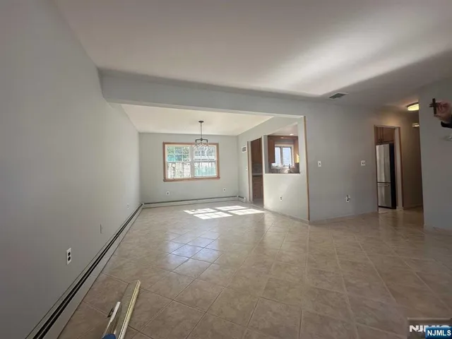 an empty room with a empty space and windows