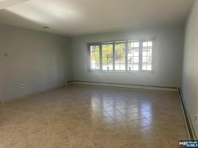 an empty room with a empty space and windows