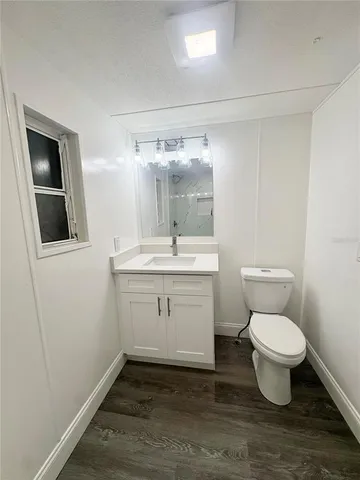 a bathroom with a toilet sink and a mirror