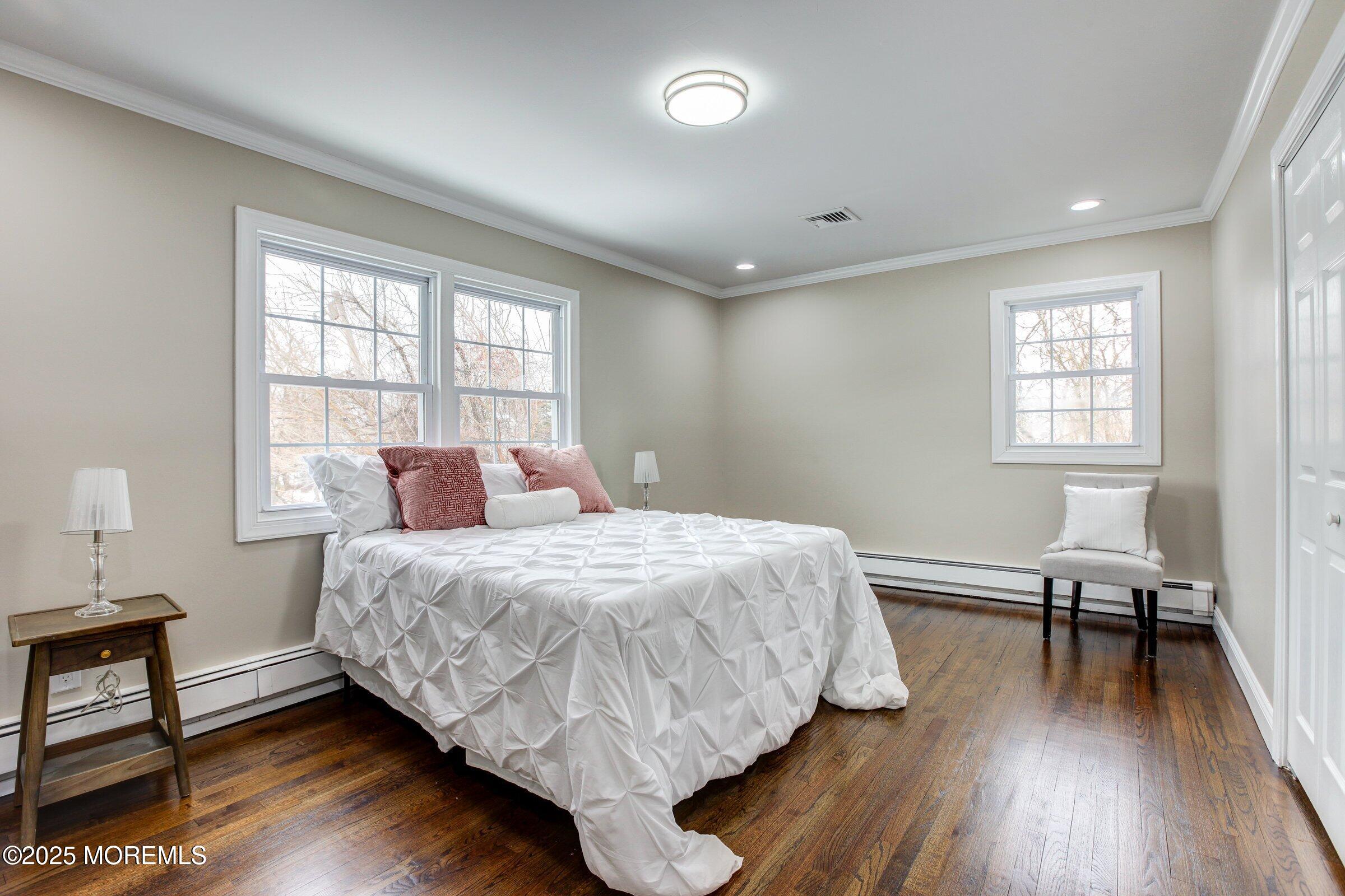119 E Road Belford, NJ 07718 - Photo 13 of 21 a bedroom with a bed and wooden floor