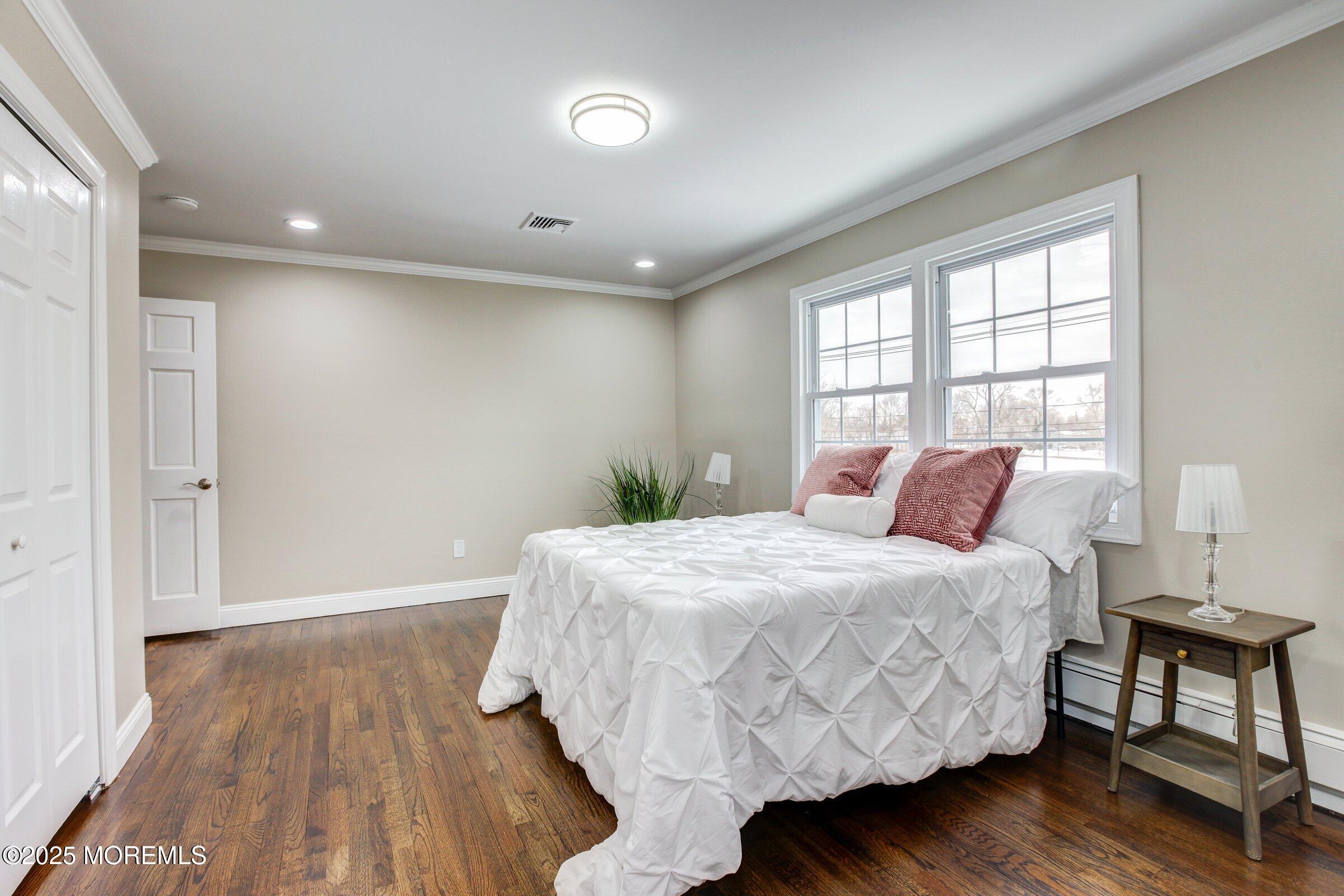 119 E Road Belford, NJ 07718 - Photo 14 of 21 a bedroom with a bed and wooden floor