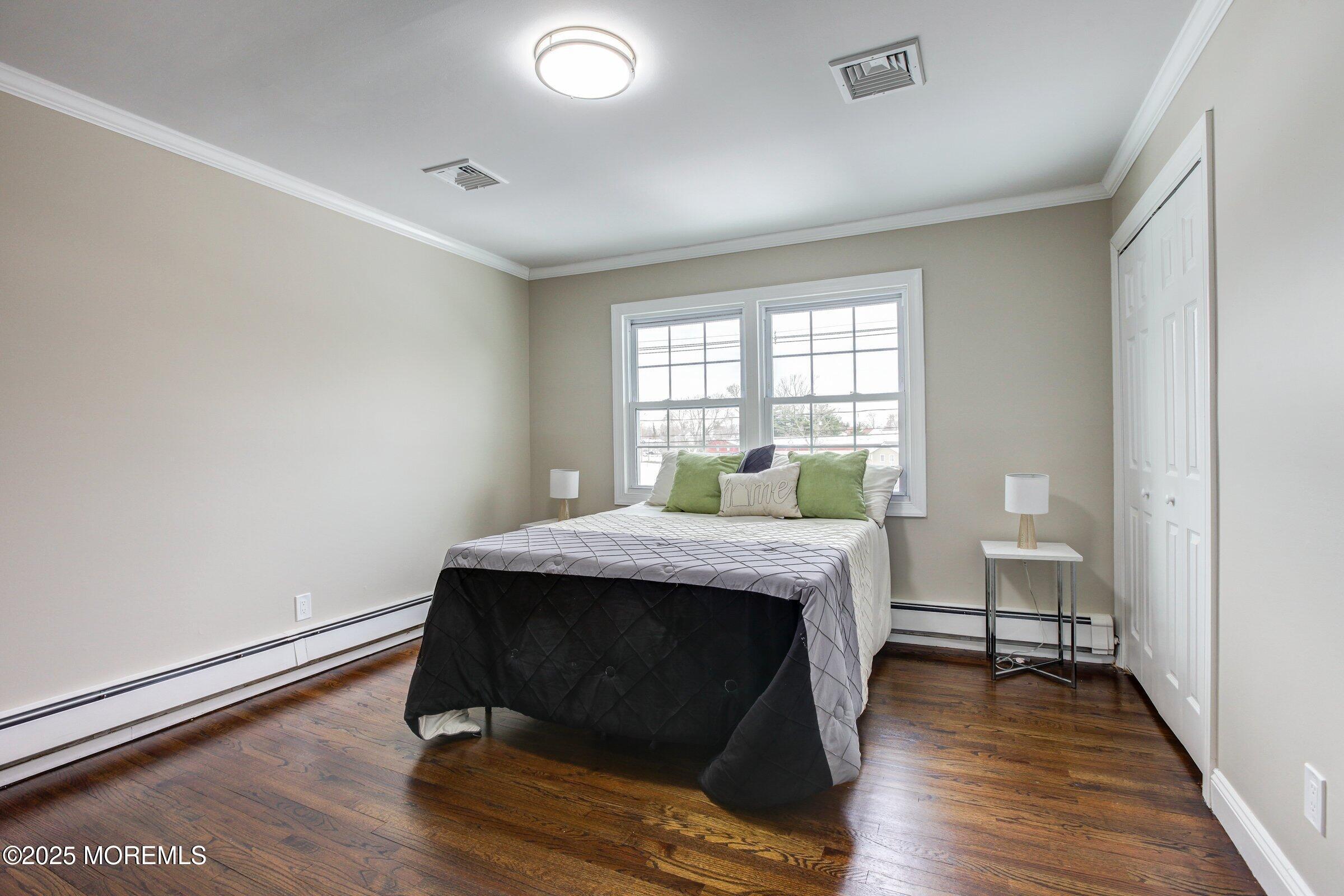 119 E Road Belford, NJ 07718 - Photo 15 of 21 a bedroom with a bed and wooden floor