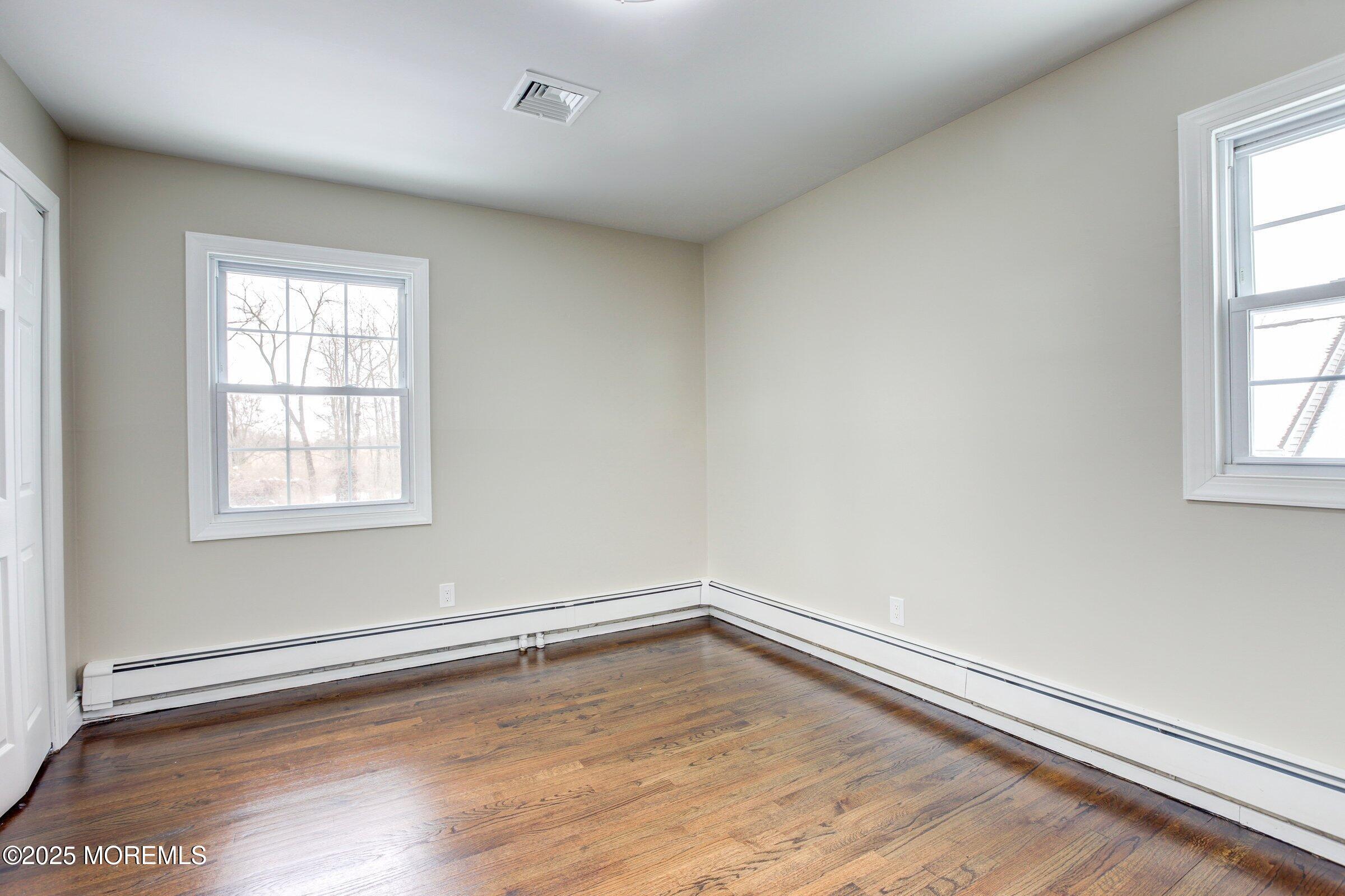 119 E Road Belford, NJ 07718 - Photo 16 of 21 an empty room with wooden floor and windows