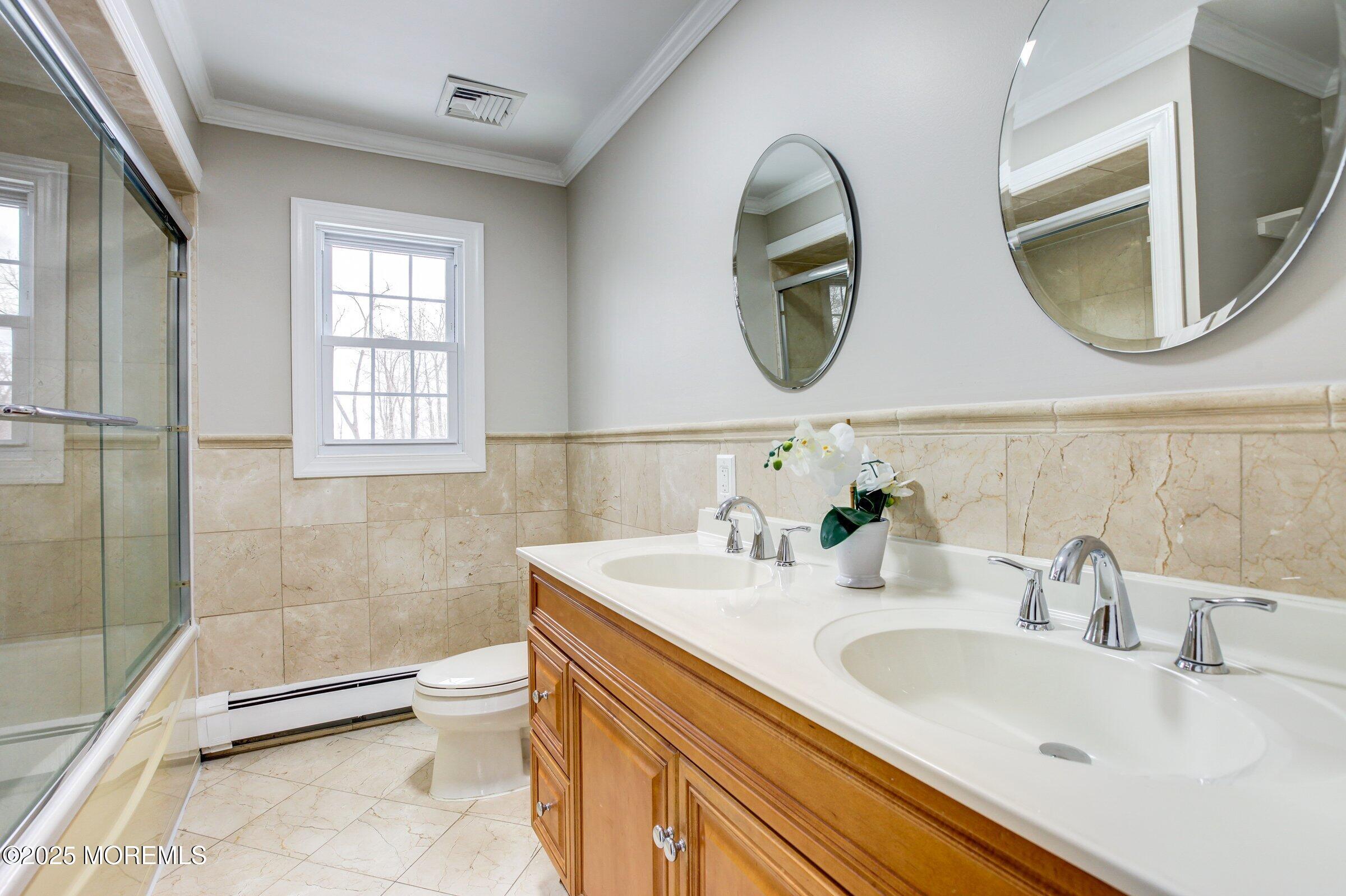 119 E Road Belford, NJ 07718 - Photo 17 of 21 a bathroom with a granite countertop toilet a sink and a mirror