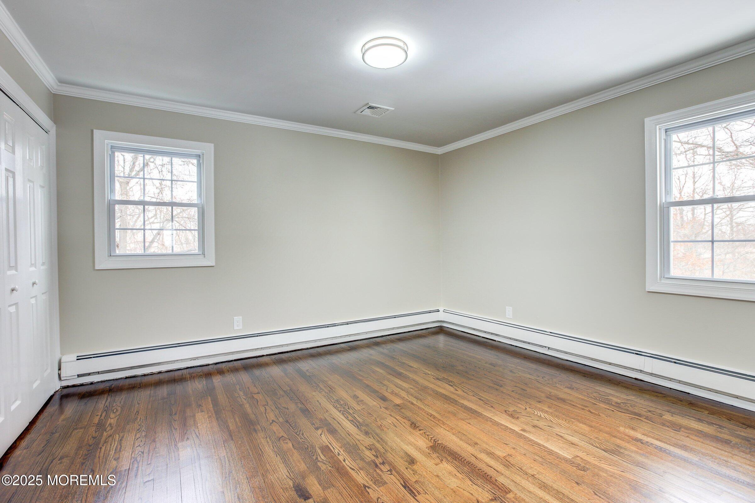 119 E Road Belford, NJ 07718 - Photo 18 of 21 an empty room with wooden floor and windows