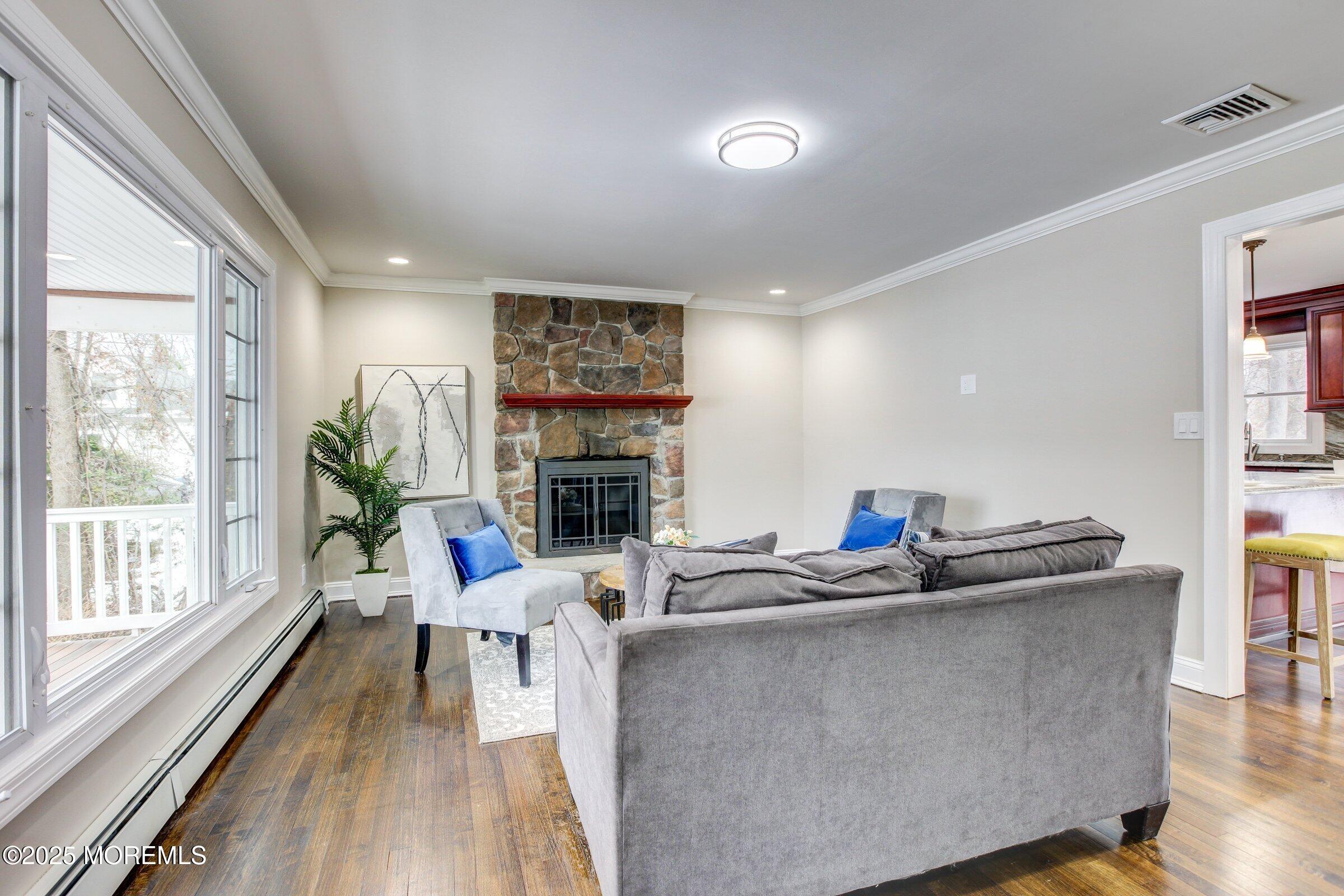 119 E Road Belford, NJ 07718 - Photo 2 of 21 a living room with furniture a fireplace and a large window