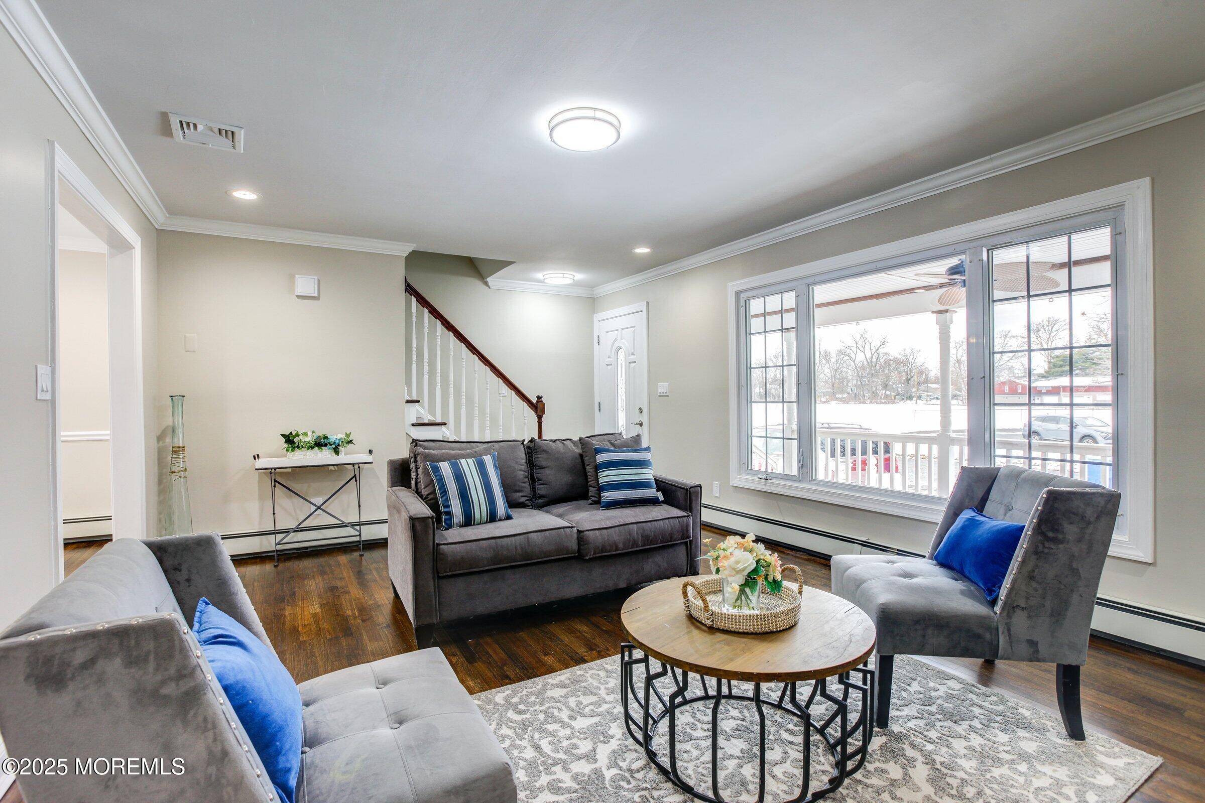 119 E Road Belford, NJ 07718 - Photo 4 of 21 a living room with furniture and a wooden floor